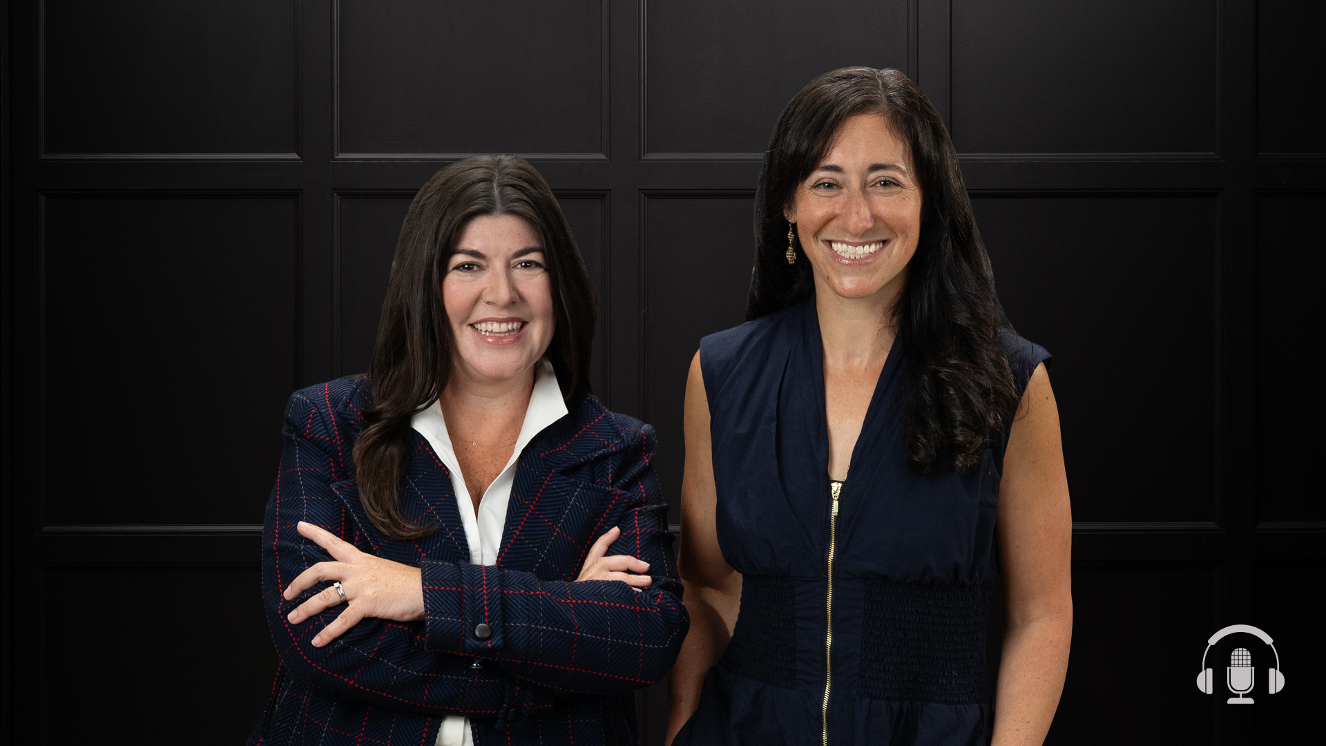 Two women standing side-by-side and smiling against a dark paneled backdrop, with a podcast microphone icon visible in the bottom right corner.