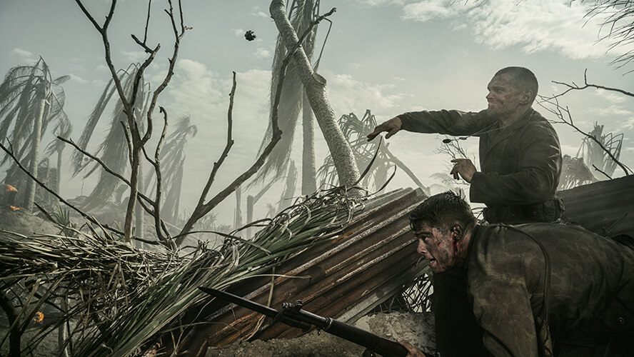 Actor Ray Nicholson throws a grenade in a battle scene from “The Mosquito Bowl.”