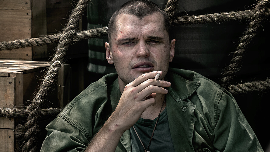 Actor Ray Nicholson smokes a cigarette in a scene from “The Mosquito Bowl.”