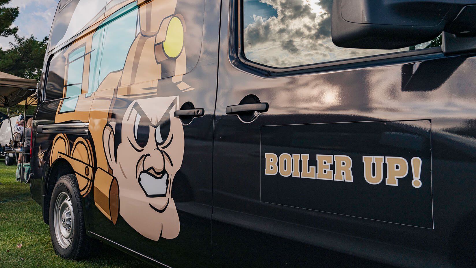 The passenger side of the Thompson family van, which reads Boiler Up!