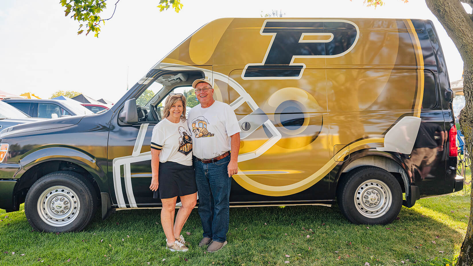 Penny and David Thompson in front of their van.  