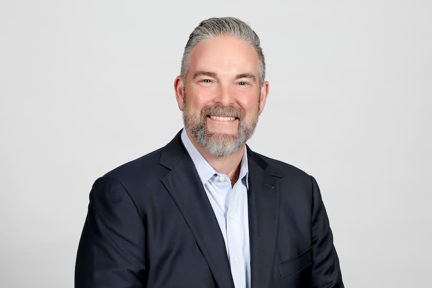 Posed shot of man in front of white background.
